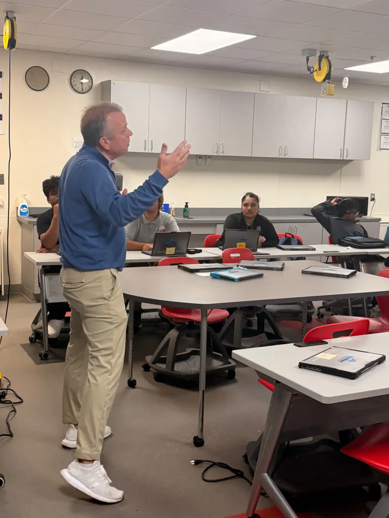 A guest speaker engaging students during a classroom career-readiness session.