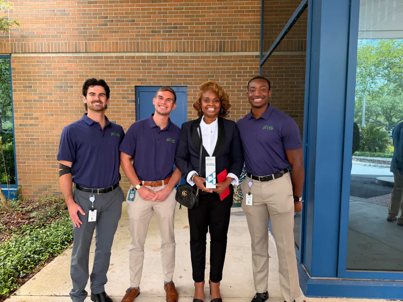 Pamela Coleman with three workforce and industry partners after an education event.